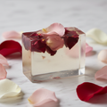 Clear transparent glycerin soap bar with rose petals embedded inside and on top